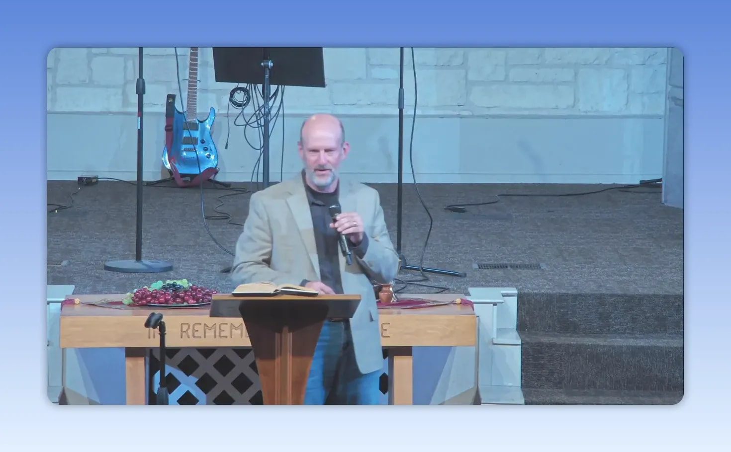 Pastor speaking directly to the congregation at a church podium during a sermon on motherhood’s influence