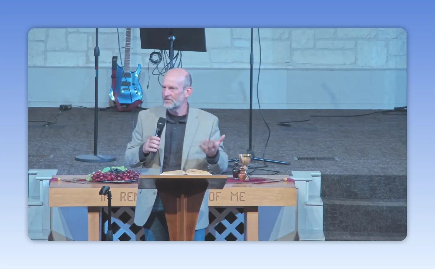 Pastor speaking with open Bible on the podium while addressing hope and God’s plan for mothers