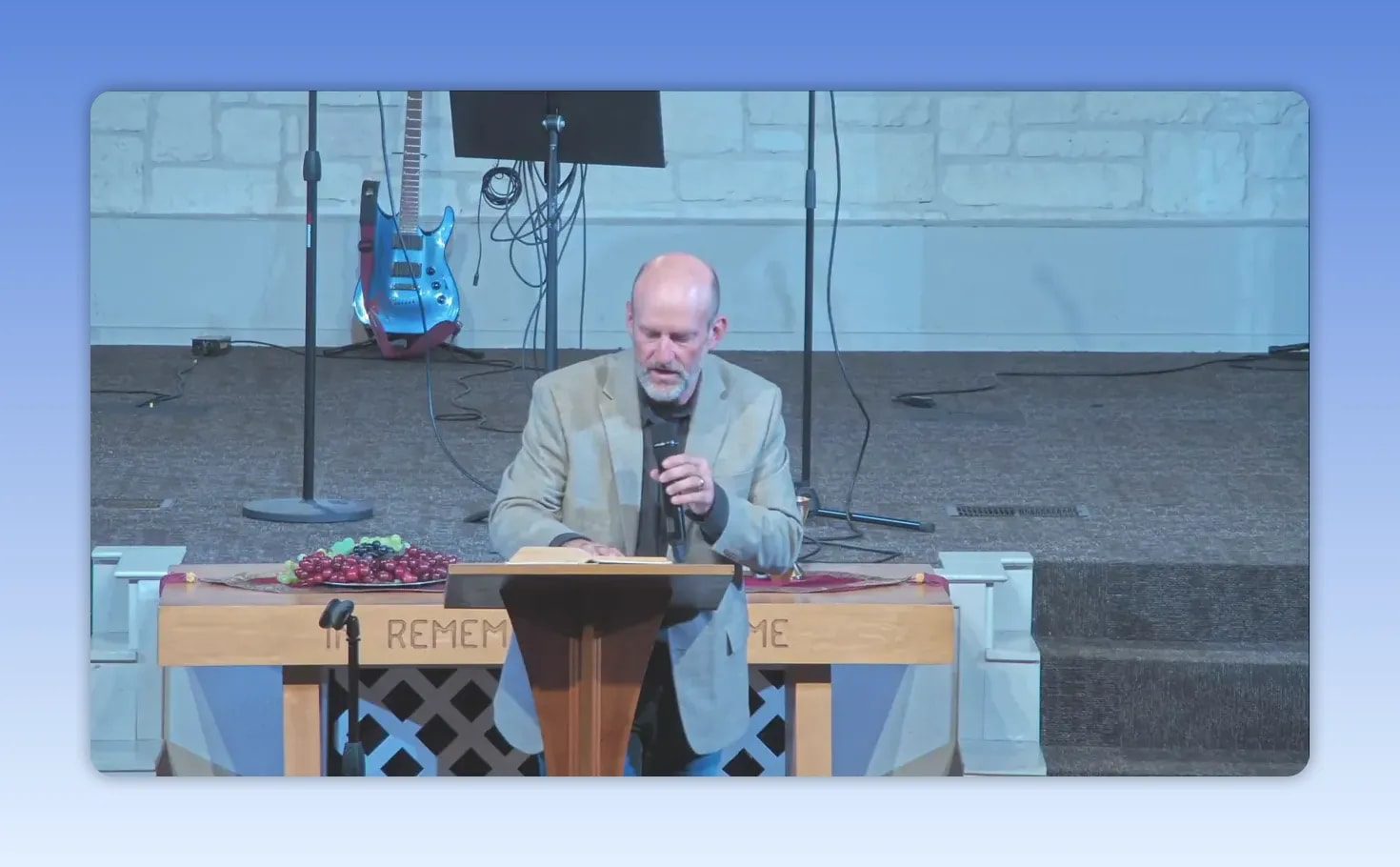 Speaker at church lectern holding a microphone during a sermon about Hannah and faithful motherhood